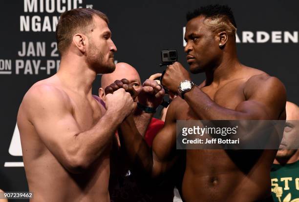 Stipe Miocic and Francis Ngannou of Cameroon face off during the UFC 220 weigh-in at TD Garden on January 19, 2018 in Boston, Massachusetts.