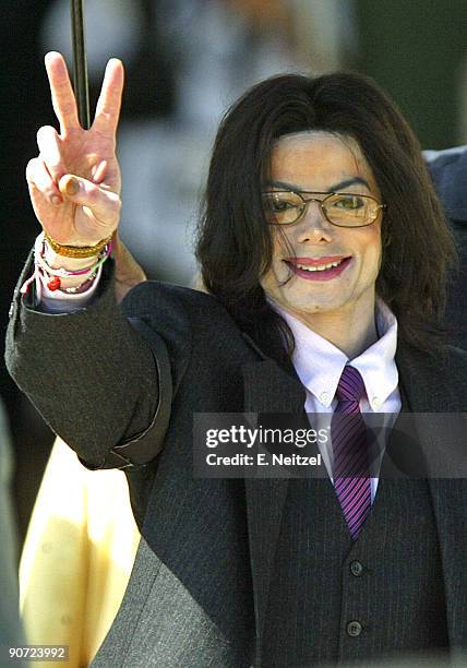 Michael Jackson flashes his trademark peace sign to supporters as he leaves the Santa Barbara Superior Court after a half day of testimony in...