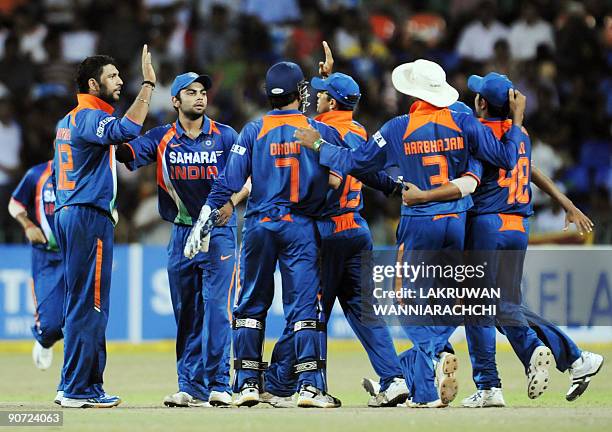 Indian bowler Yuvraj Singh celebrates with teammates after the dismissal of Sri Lankan batsman Angelo Mathews during the Tri-Nation Championship...