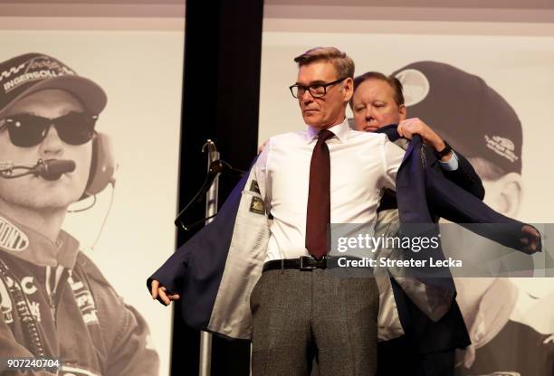 Chief Executive Officer and Chairman, Brian France, presents Ray Evernham with his Hall of Fame jacket during a banquet before the NASCAR Hall of...