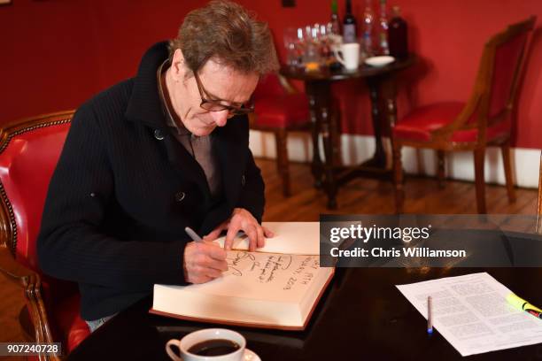 Bryan Cranston signing guest book and posters at The Cambridge Union on January 19, 2018 in Cambridge, Cambridgeshire.