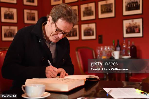 Bryan Cranston signing guest book and posters at The Cambridge Union on January 19, 2018 in Cambridge, Cambridgeshire.