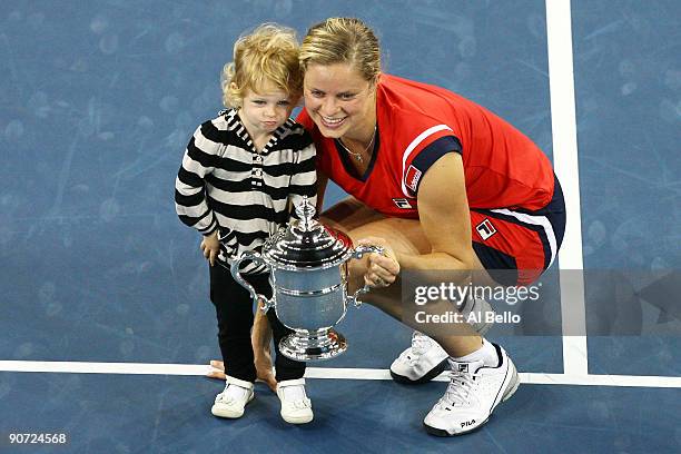 Kim Clijsters of Belgium and daughter Jada pose with the championship trophy after Clijsters defeated Caroline Wozniacki of Denmark in the Women�s...