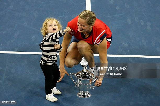 Kim Clijsters of Belgium and daughter Jada pose with the championship trophy after Clijsters defeated Caroline Wozniacki of Denmark in the Women�s...