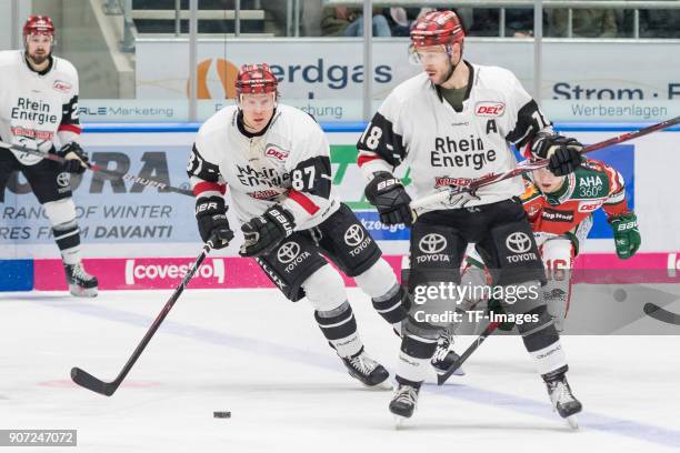 Philip Gogulla of Koelner Haie and Kai Hospelt of Koelner Haie control the ball during the DEL match between Augsburger Panther and Koelner Haie at...