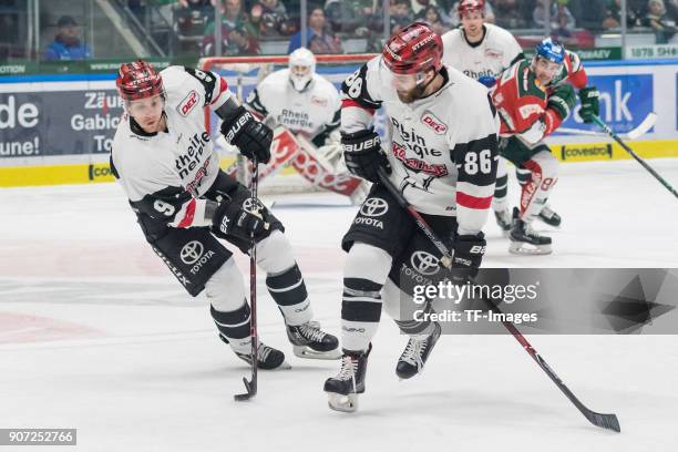 Shawn Lalonde of Koelner Haie and Ben Hanowski of Koelner Haie control the ball during the DEL match between Augsburger Panther and Koelner Haie at...