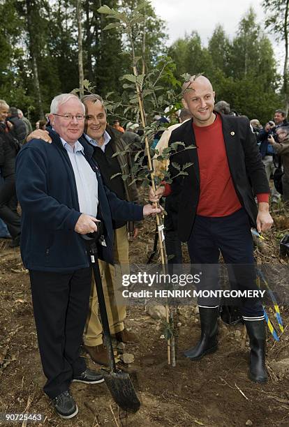 Irish Agriculture Minister Brendan Smith , Slovenian counterpart Milan Pogacnik and Poland's Andrzej Dycha plant a tree during a visit with EU...