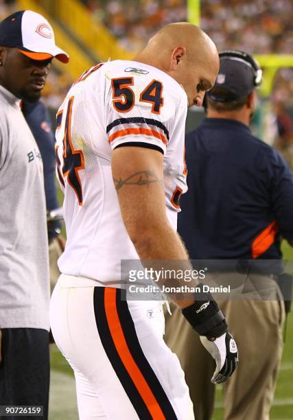 Brian Urlacher of the Chicago Bears stands on the sidelines after being injured near the end of the first half against the Green Bay Packers on...
