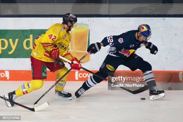 Alexei Dmitriev of Duesseldorfer EG vies Patrick Hager of Red Bull Munich during the 43th game day of the German Ice Hockey League between Red Bull...