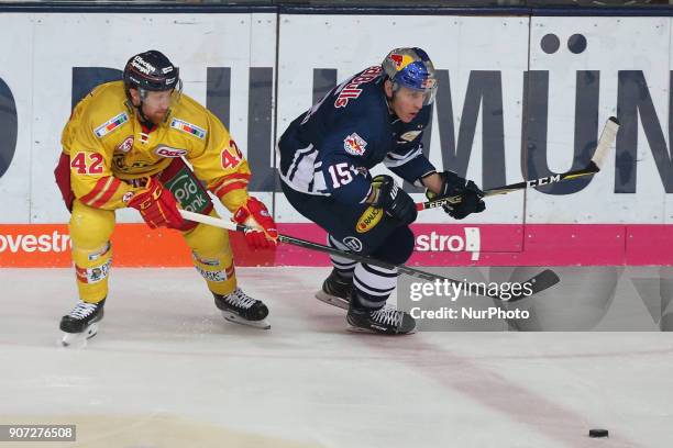 Alexei Dmitriev of Duesseldorfer EG vies Jason Jaffray of Red Bull Munich during the 43th game day of the German Ice Hockey League between Red Bull...