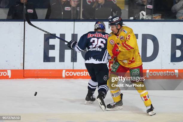 Yannic Seidenberg of Red Bull Munich vies Spencer Machacek of Duesseldorfer EG during the 43th game day of the German Ice Hockey League between Red...