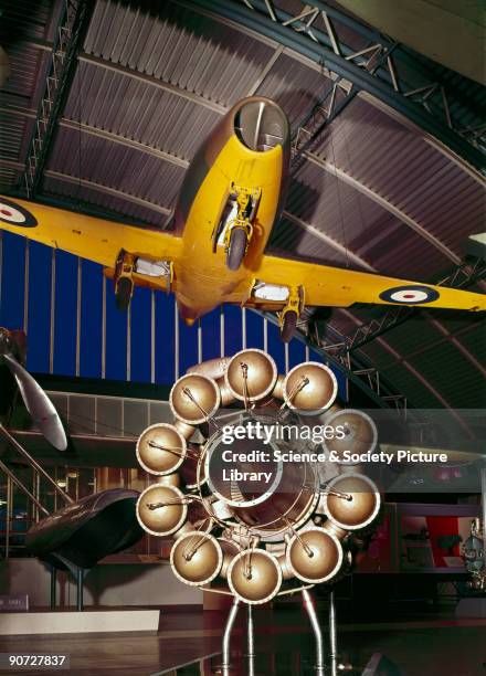 The Whittle 1 Jet Propulsion Engine, with one metal framed display notice, seen from 3/4 front view beneath the Gloster E28/39 in which it was...