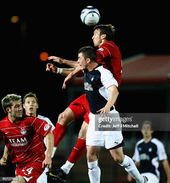 Thomas Scobbie of Falkirk tackles Lee Miller of Aberdeen during the Clydesdale Bank Scottish Premier league match between Falkirk and Aberdeen at...