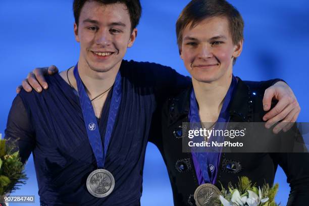 Silver medallist Dmitri Aliev and bronze medallist Mikhail Kolyada poses with his medal after the men's free skating at the 2018 ISU European Figure...