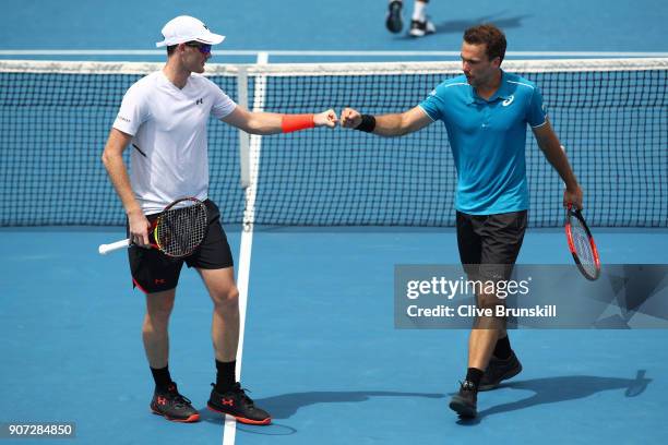 Jamie Murray of Great Britain and Bruno Soares of Brazil talk tactics in their second round men's doubles match against Leander Paes of India and...