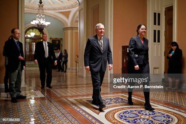 Senate Majority Leader Mitch McConnell, accompanied by Secretary for the Majority Laura Dove, walks from the Senate chamber to his office at the U.S....