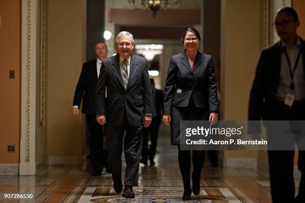 Senate Majority Leader Mitch McConnell, accompanied by Secretary for the Majority Laura Dove, walks to the Senate chamber at the U.S. Capitol January...