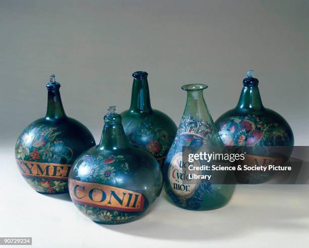 Carboys are large globular glass bottles with a narrow neck, used for holding acids or other corrosive liquids. These carboys originally contained...