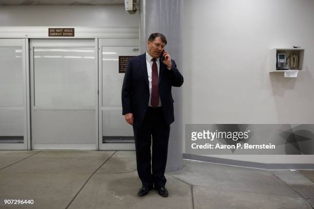 Sen. Mike Rounds talks on the phone at the U.S. Capitol January 19, 2018 in Washington, DC. A continuing resolution to fund the government has passed...