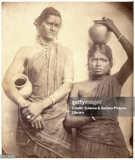 Three quarter length portrait of two women from Ceylon holding pots by Julia Margaret Cameron . Cameron's photographic portraits are considered among...