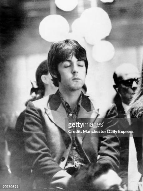 Caption reads: 'Why has Beatle Paul got his eyes shut? - he's meditating'. Paul McCartney formed the Beatles in 1960 with John Lennon , George...
