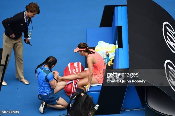 Lauren Davis of the United States receives medical treatment after injuring her foot in a fall in her third round match against Simona Halep of...