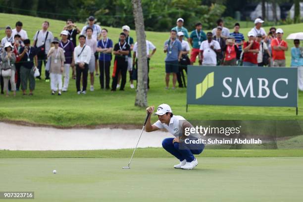 Ryo Ishikawa of Japan lines up his shot on the seventeenth hole of Round 2 on day 3 of the Singapore Open at Sentosa Golf Club on January 20, 2018 in...