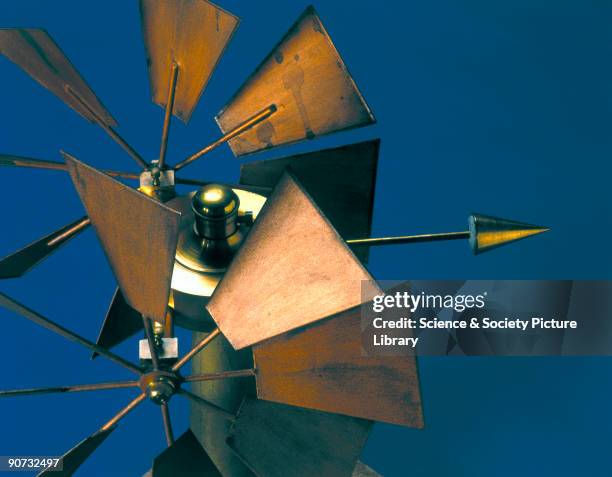 Detail of a windmill style anemometer used for measuring wind force with a pair of eight-blade vanes and a direction pointer. This example was...