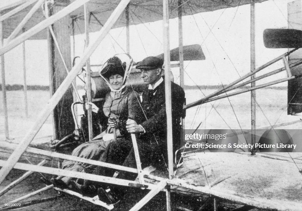 Wilbur Wright and Madame Hart Berg seated in a flying machine, early 1900s.
