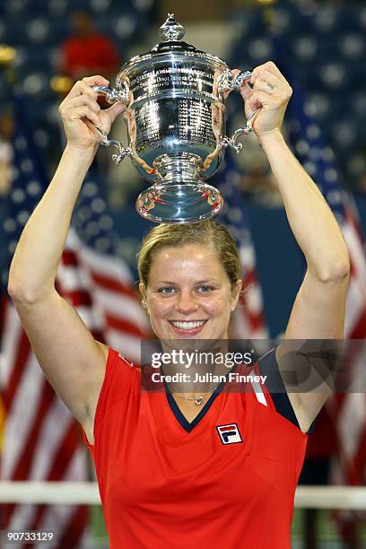 Kim Clijsters of Belgium holds up the championship trophy after defeating Caroline Wozniacki of Denmark in the Women�s Singles final on day fourteen...