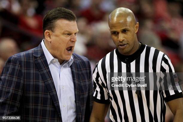 Head coach Brad Underwood of the Illinois Fighting Illini argues a call with referee Steve McJunkins in the first half against the Wisconsin Badgers...