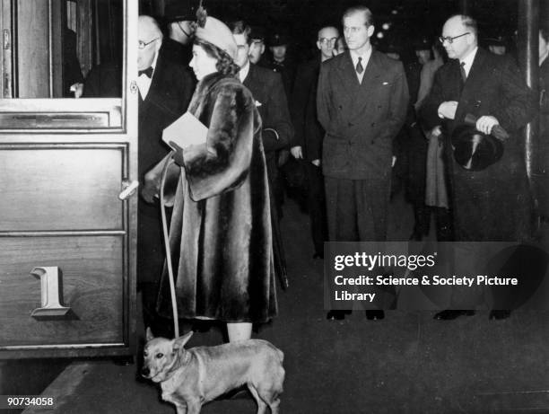 Princess Elizabeth, together with her pet corgi, board the Royal Train at Kings Cross. It is likely that this journey was made to Edinburgh on 28...