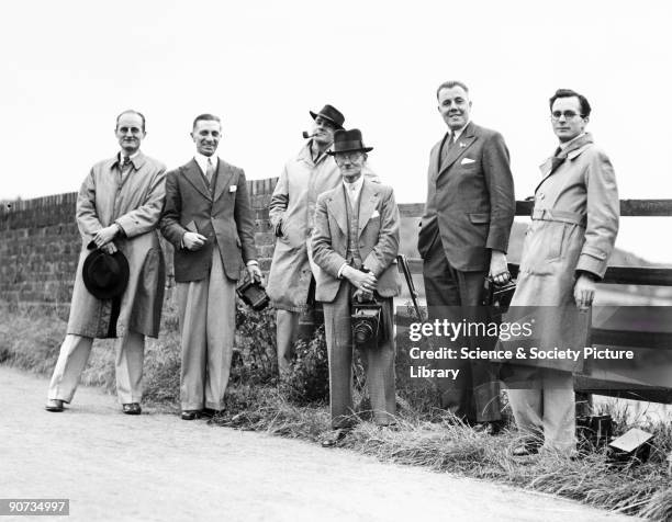 The railway photographers are shown here during an outing at Saunderton on the Great Western Railway. Smartly dressed and equipped with folding glass...