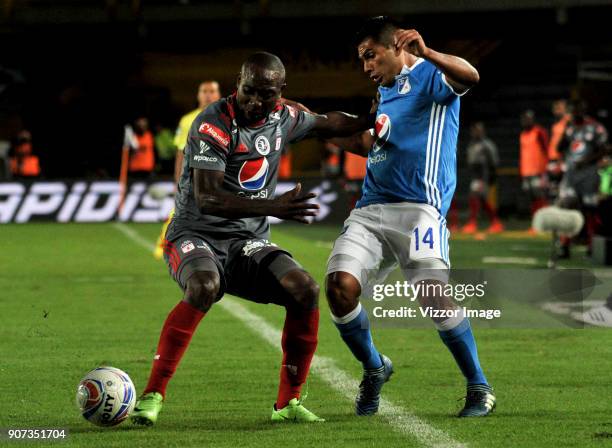 David Silva of Millonarios fights for the ball with Avimiled Rivas of America de Cali during the friendly match between Millonarios and America de...