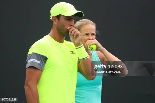 Anna-Lena Groenefeld of Germany and Robert Farah of Colombia talk tactics in their first round mixed doubles match against Storm Sanders of Australia...