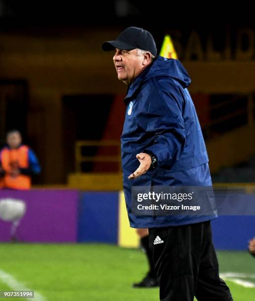 Hugo Gotardi coach of Millonarios gives instructions to his players during the friendly match between Millonarios and America de Cali as par of the...