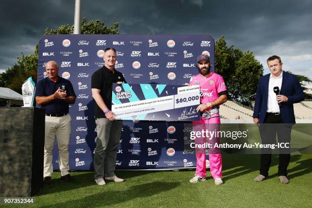 Dean Brownlie of the Knights is presented with the winning cheque after winning the Super Smash Grand Final match between the Knights and the Stags...