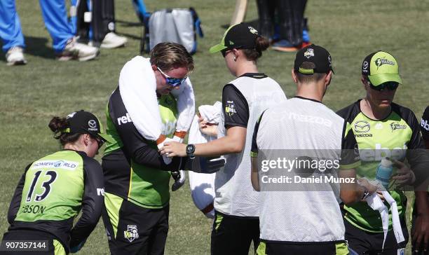 Thunder Rachel Priest gets an iced towel around her neck during the Women's Big Bash League match between the Sydney Thunder and the Adelaide...