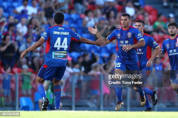 Andrew Nabbout of the Jets celebrates scoring a goal with team mate Nikolai Topor-Stanley during the round 17 A-League match between the Newcastle...