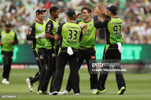 Mitchell McClenaghan of the Thunder celebrates taking the wicket of Peter Handscomb of the Stars during the Big Bash League match between the...