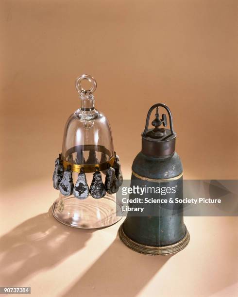 The glass model on the left has twelve lead weights which kept it submerged. The wire cage was used to contain small birds or mice so that the bell...
