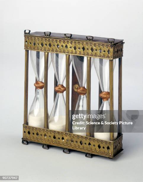 This four-way sand glass in a brass stand was hung on a wall so that the glasses could be inverted as required. They measure intervals of quarter,...