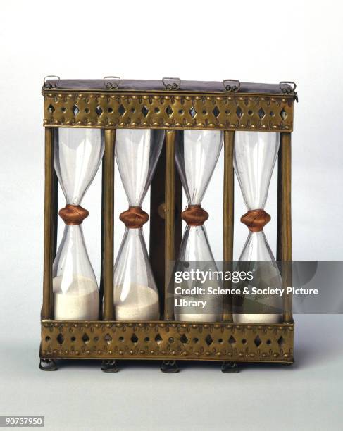 This four-way sand glass in a brass stand was hung on a wall so that the glasses could be inverted as required. They measure intervals of quarter,...