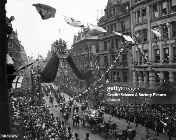 Procession passing along a busy London thoroughfare during the Coronation of Edward VII . On the right is a J Lyons tea room.