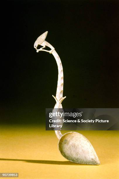 Bone spoon with a fish and a bird carved on the stem.