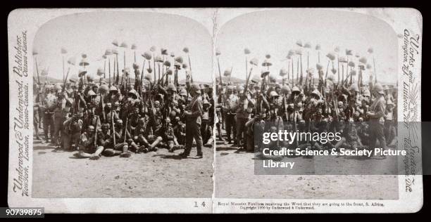 Contingent of soldiers raise their pith helmets in a show of jubilation at the news they are to be sent into action. One of a boxed set of...