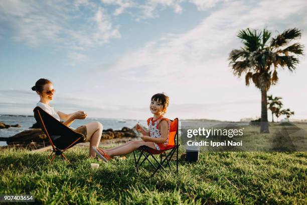 Mother and child enjoying camping by the sea