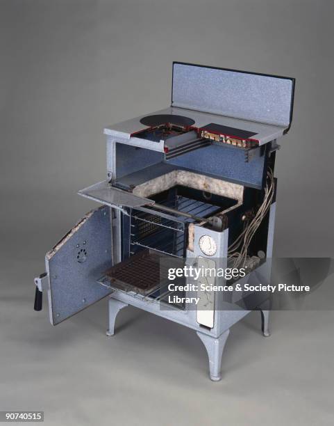 Fully enamelled with cast-metal hotplate and griller-boiler, oven and oven thermostat. Sectioned to show details of the wiring, the hot plate...