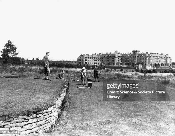 The 18th tee on the Queen's Golf Course, Gleneagles, Perth and Kinross, Scotland, 1923. A woman and three men play golf, against a backdrop of the...