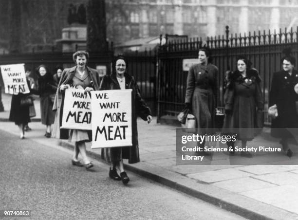 'Housewives League members leave the House of Commons on the way to the Ministry of Food'.